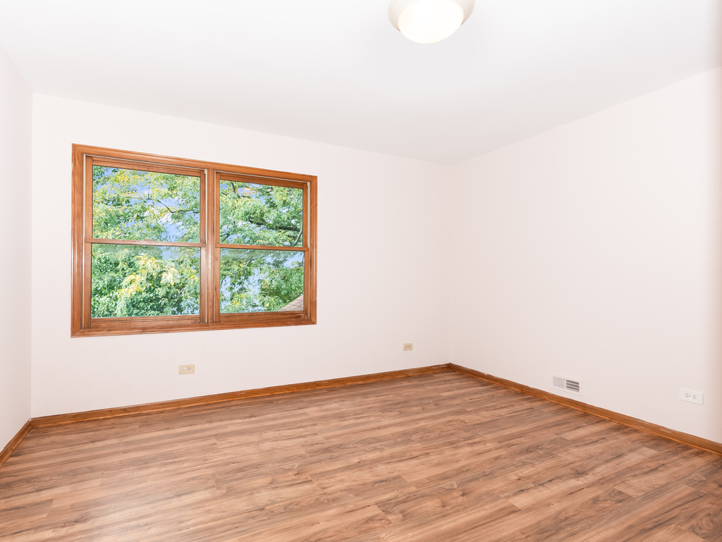 21322 Georgetown Road Frankfort, IL 60423 - Photo 17 of 28 an empty room with wooden floor and windows