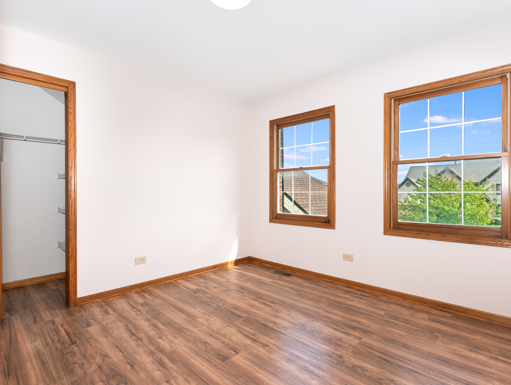 21322 Georgetown Road Frankfort, IL 60423 - Photo 20 of 28 an empty room with wooden floor and windows