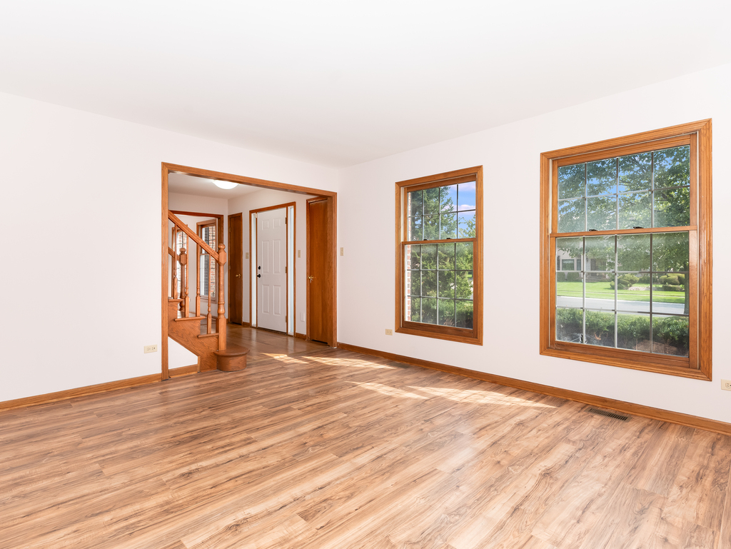 21322 Georgetown Road Frankfort, IL 60423 - Photo 2 of 28 a view of an empty room with wooden floor and a window