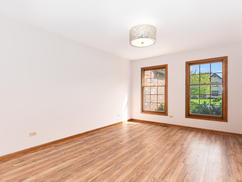 21322 Georgetown Road Frankfort, IL 60423 - Photo 4 of 28 an empty room with wooden floor and windows