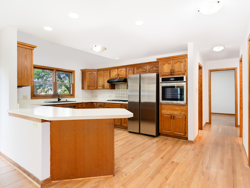21322 Georgetown Road Frankfort, IL 60423 - Photo 10 of 28 a kitchen with stainless steel appliances granite countertop a refrigerator a sink a stove and oven