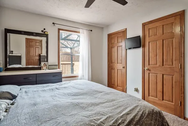 a bedroom with a large bed and a large window