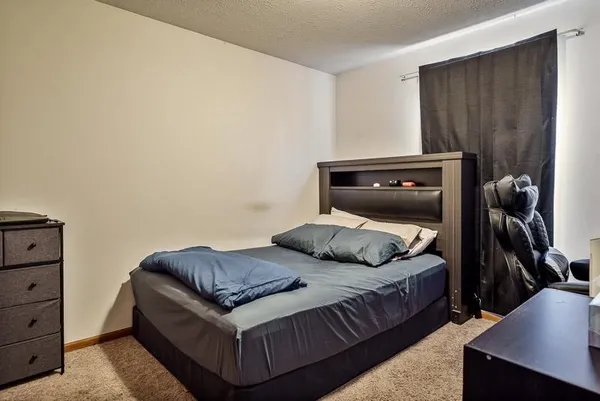 a bedroom with a bed and a closet