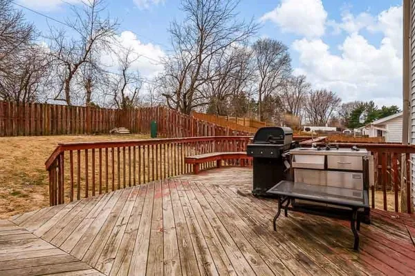 a view of a roof deck with wooden floor and fence