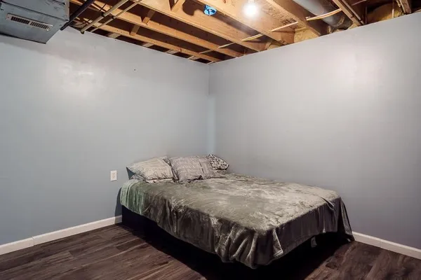 a bed sitting in a bedroom next to a window