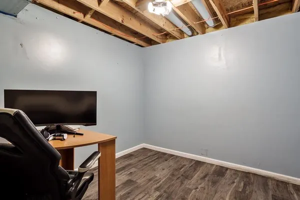 a view of workspace with wooden floor and tv