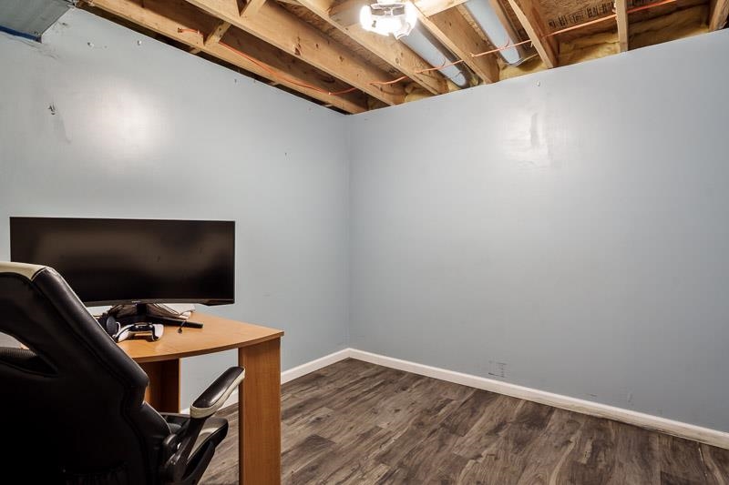 5094 Grand Cape Road Rockford, IL 61109 - Photo 4 of 30 a view of workspace with wooden floor and tv