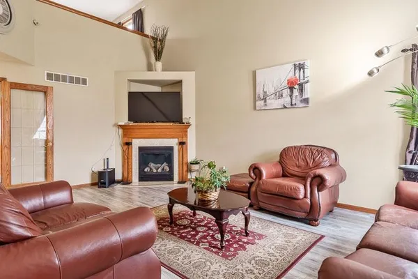 a living room with furniture and a fireplace