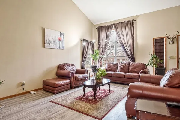 a living room with furniture a rug and a window