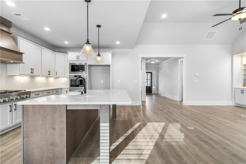 2321 Pebble Trail Monroe, GA 30656 - Photo 11 of 21 a kitchen with kitchen island a sink stainless steel appliances and cabinets