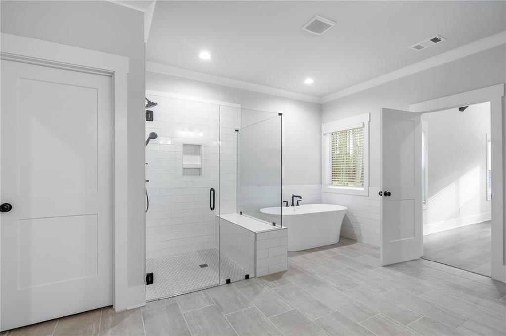 2321 Pebble Trail Monroe, GA 30656 - Photo 19 of 21 a spacious bathroom with a bathtub shower and sink