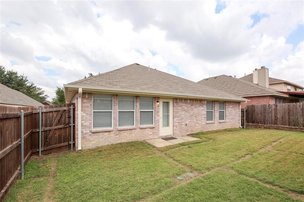 5961 Cheyenne Way Frisco, TX 75034 - Photo 30 of 33 Brick exterior featuring multiple windows with blinds, a side-entry door, and a shingled roof