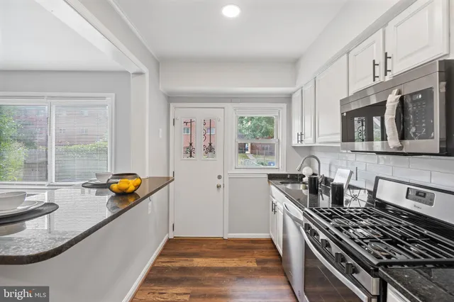 a kitchen that has a sink and a stove