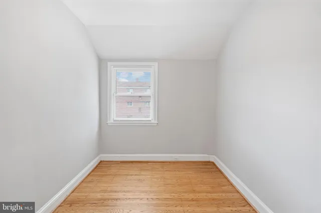 a view of a room with wooden floor and window