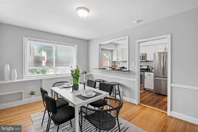 a view of a dining room with furniture window and wooden floor
