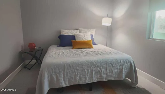 a bedroom with a bed and a window