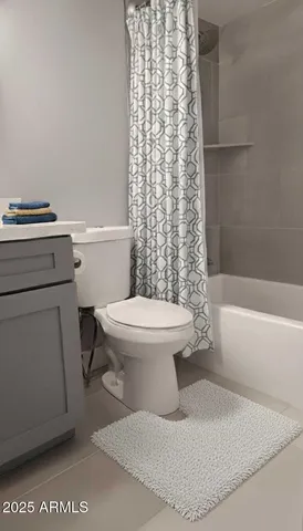 a white toilet sitting next to a bath tub