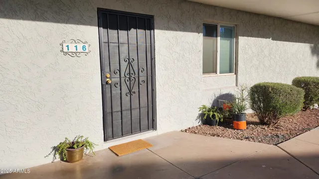 a bedroom with a bed and a potted plant