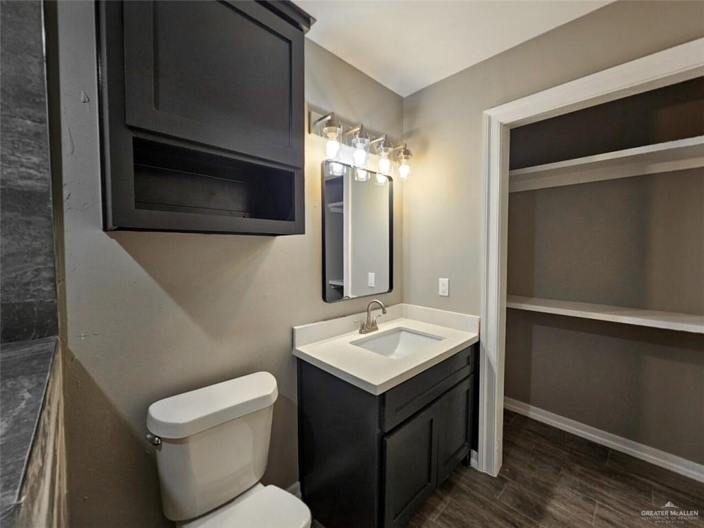 305 South Raul Longoria Road Edinburg, TX 78542 - Photo 12 of 18 a bathroom with a toilet sink and mirror