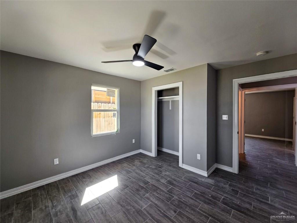 305 South Raul Longoria Road Edinburg, TX 78542 - Photo 13 of 18 an empty room with wooden floor and windows