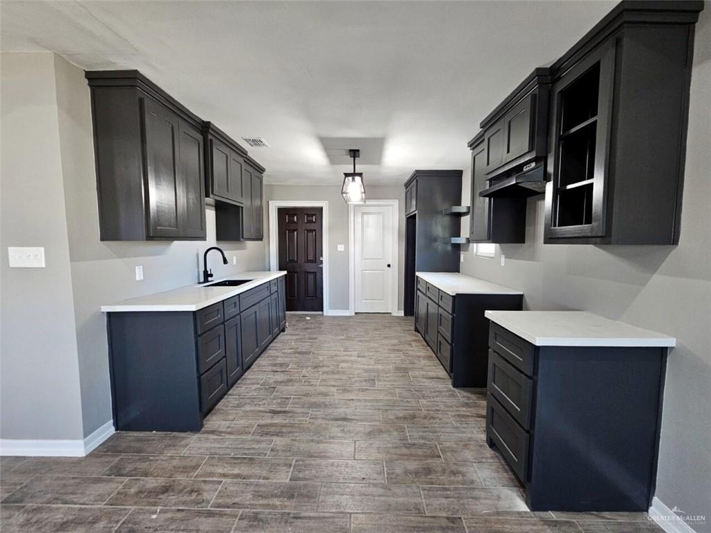 305 South Raul Longoria Road Edinburg, TX 78542 - Photo 7 of 18 a large kitchen with stainless steel appliances kitchen island granite countertop a large counter top and cabinets