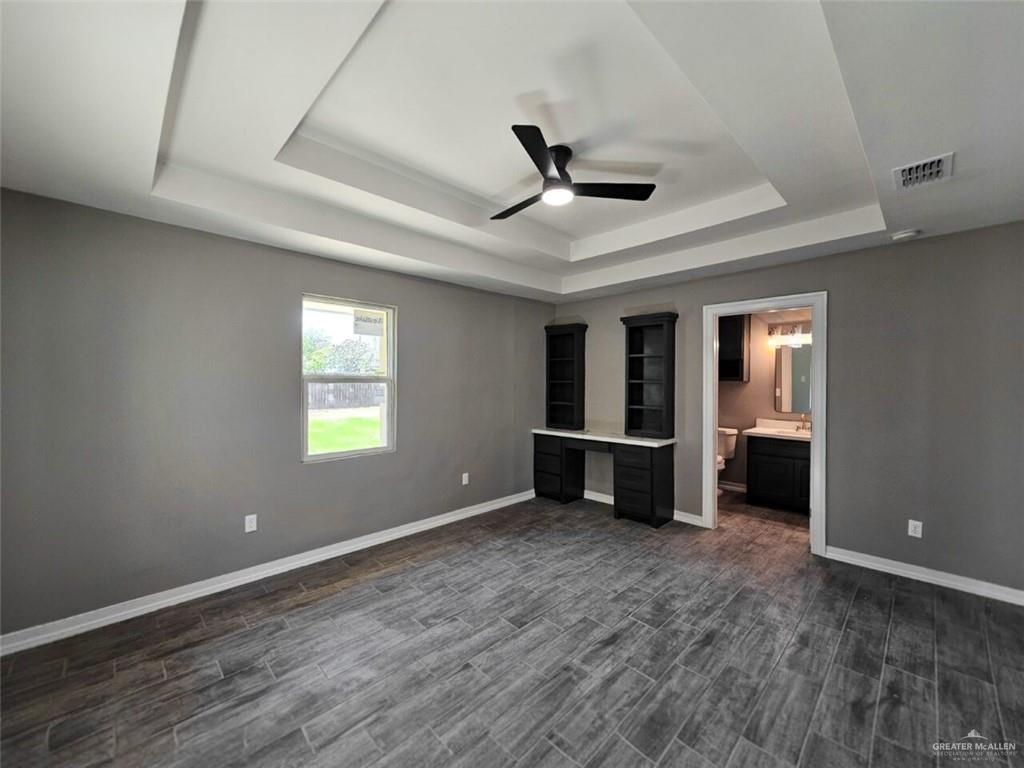 305 South Raul Longoria Road Edinburg, TX 78542 - Photo 9 of 18 a view of an empty room with window and wooden floor