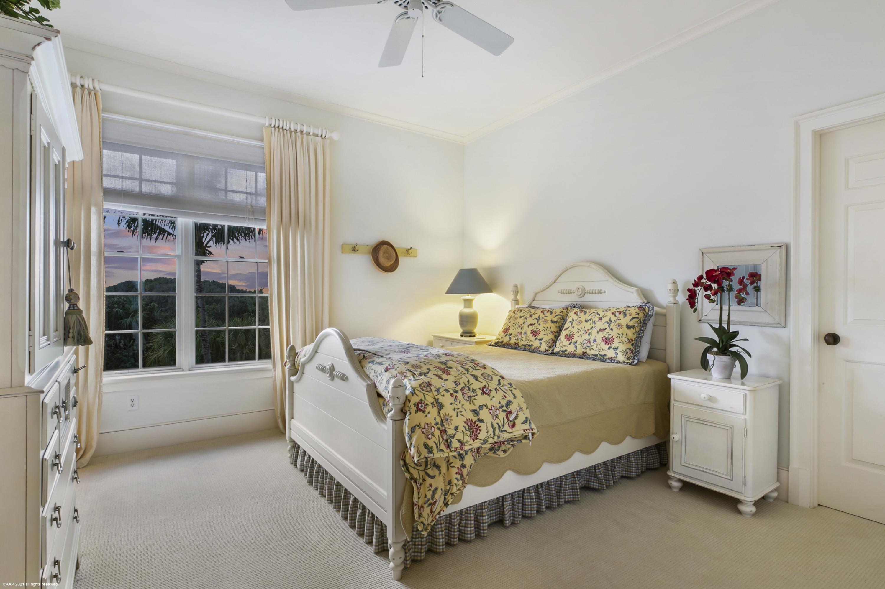 60 Beachside Drive, Unit 201 Orchid, FL 32963 - Photo 13 of 23 a bed sitting in a bedroom next to a window