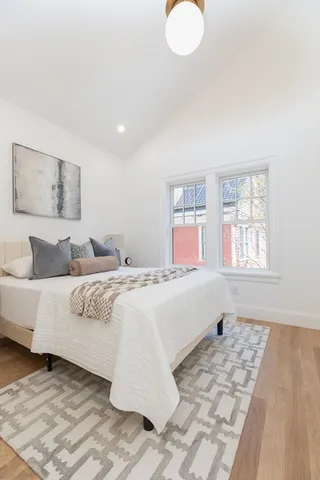 a spacious bedroom with a large bed and a window