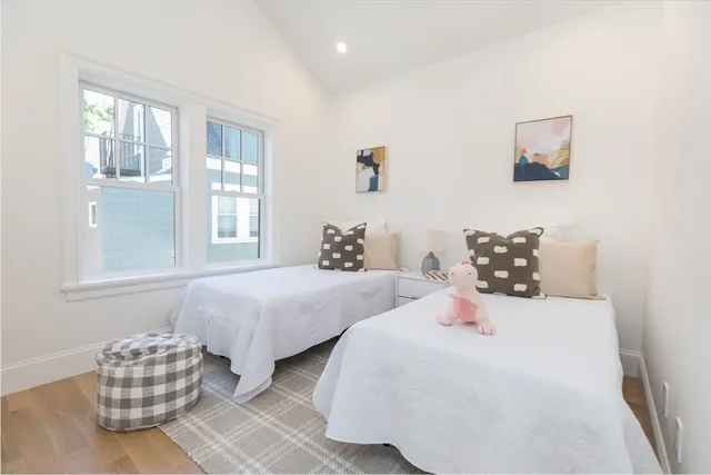 a bedroom with two beds and a couch