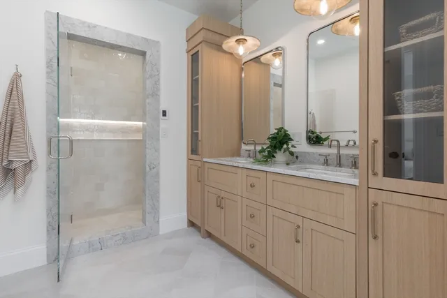 a bathroom with a double vanity sink and mirror