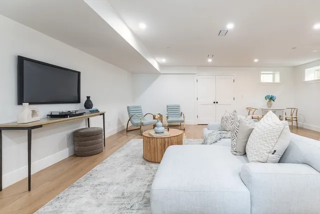 a living room with furniture and flat screen tv