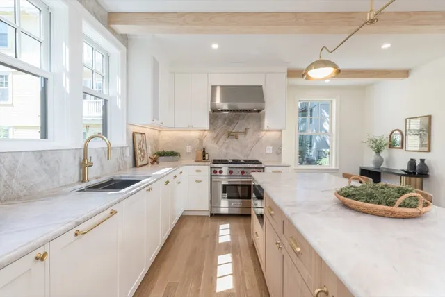 a kitchen with a sink stove and cabinets