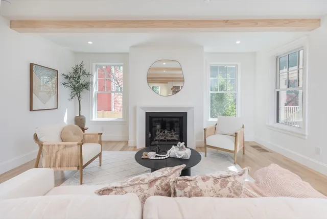 a living room with furniture a window and a fireplace