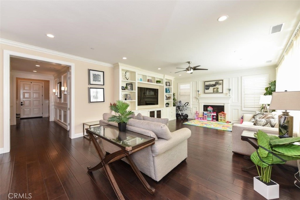 62 Rossmore Irvine, CA 92620 - Photo 11 of 43 a living room with fireplace furniture and a wooden floor