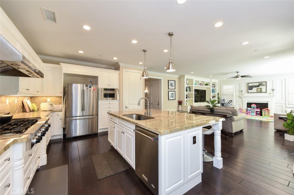 62 Rossmore Irvine, CA 92620 - Photo 2 of 43 a large kitchen with stainless steel appliances lots of counter space and wooden floor