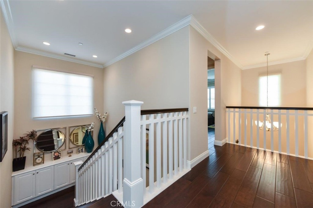 62 Rossmore Irvine, CA 92620 - Photo 25 of 43 a view of a hallway with wooden floor and windows