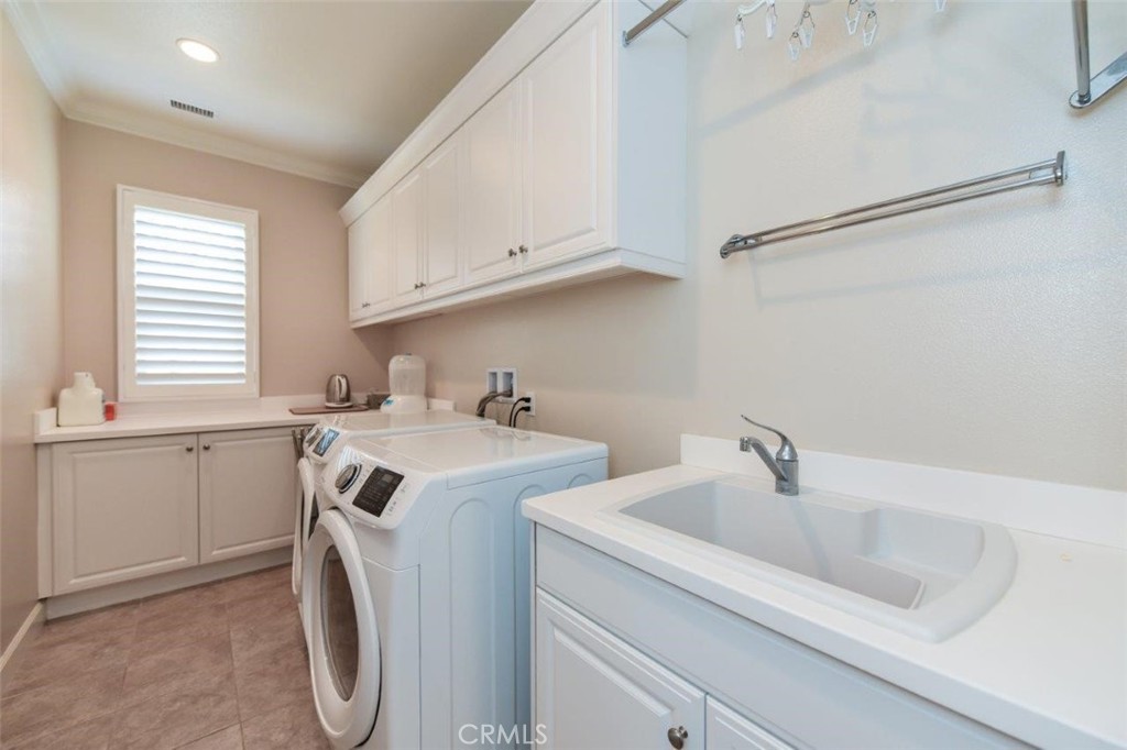 62 Rossmore Irvine, CA 92620 - Photo 26 of 43 a utility room with cabinets washer and dryer