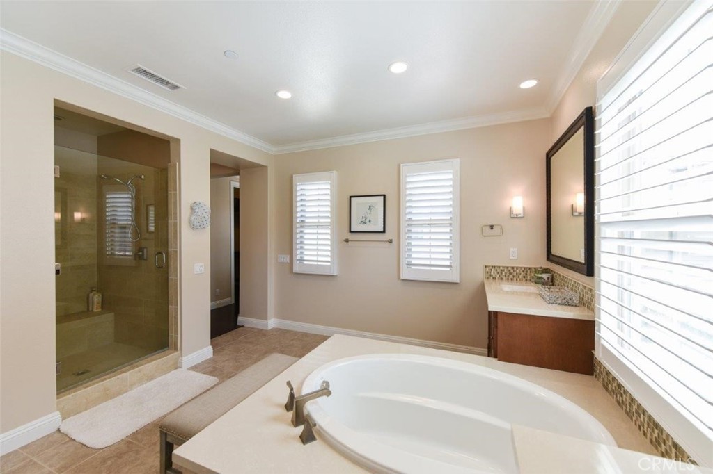 62 Rossmore Irvine, CA 92620 - Photo 30 of 43 a bathroom with a tub sink and mirror