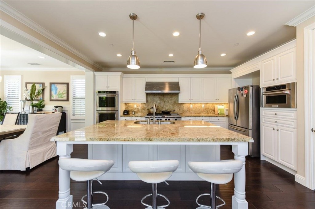 62 Rossmore Irvine, CA 92620 - Photo 3 of 43 a large kitchen with a table and chairs