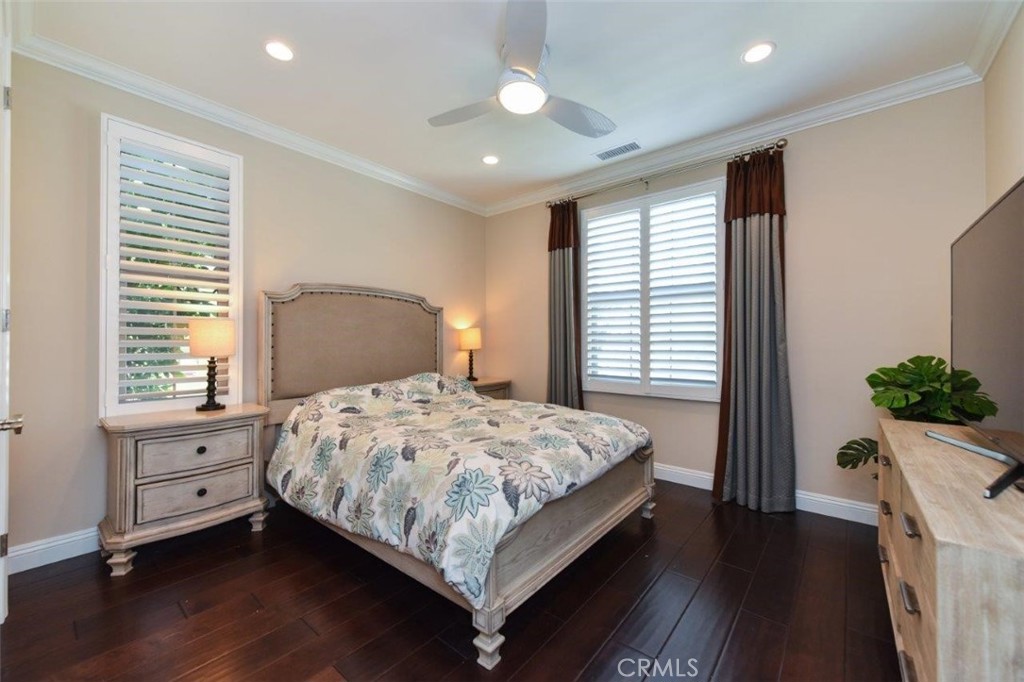 62 Rossmore Irvine, CA 92620 - Photo 31 of 43 a bedroom with a large bed and a chandelier