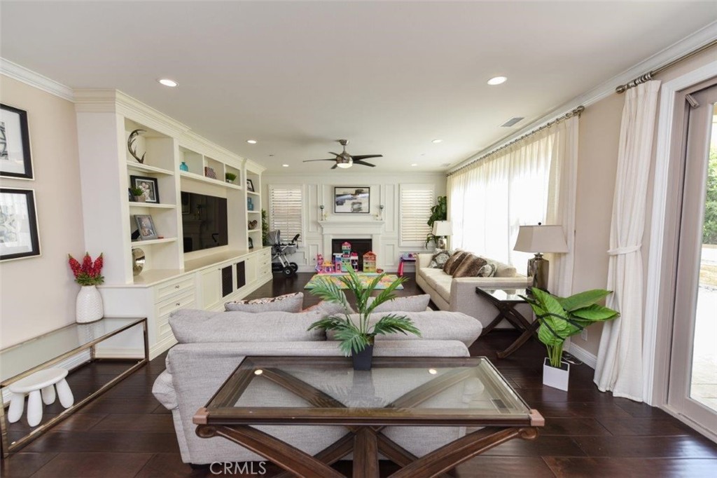 62 Rossmore Irvine, CA 92620 - Photo 4 of 43 a living room with furniture dining table and a flat screen tv