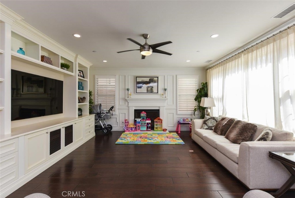 62 Rossmore Irvine, CA 92620 - Photo 5 of 43 a living room with fireplace furniture and a flat screen tv