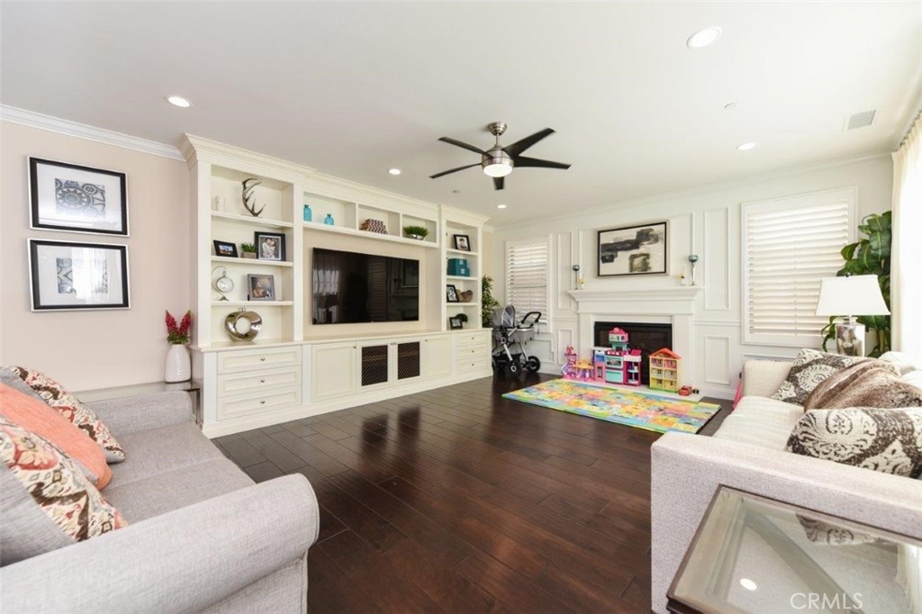 62 Rossmore Irvine, CA 92620 - Photo 6 of 43 a living room with furniture a flat screen tv and a fireplace