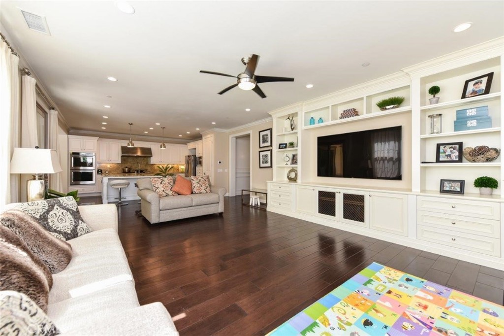 62 Rossmore Irvine, CA 92620 - Photo 7 of 43 a living room with furniture and a flat screen tv