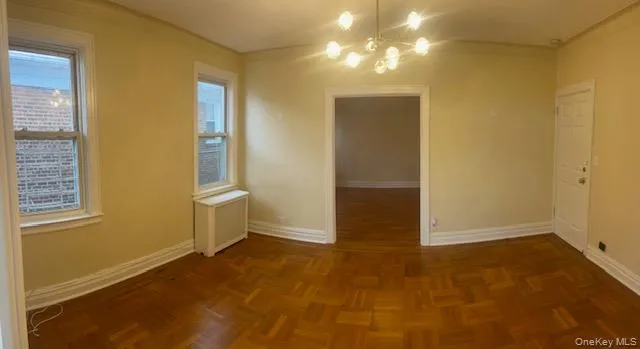 an empty room with windows and entrance