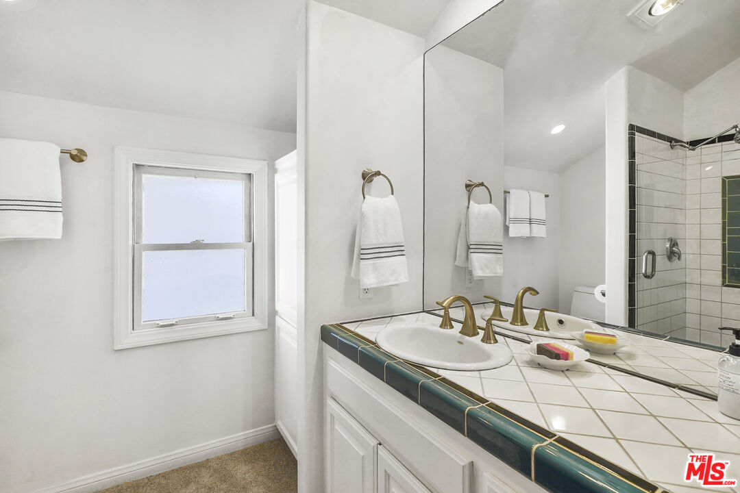 29355 Heathercliff Road, Unit GUESTHOUSE Malibu, CA 90265 - Photo 14 of 26 a bathroom with a sink and a mirror