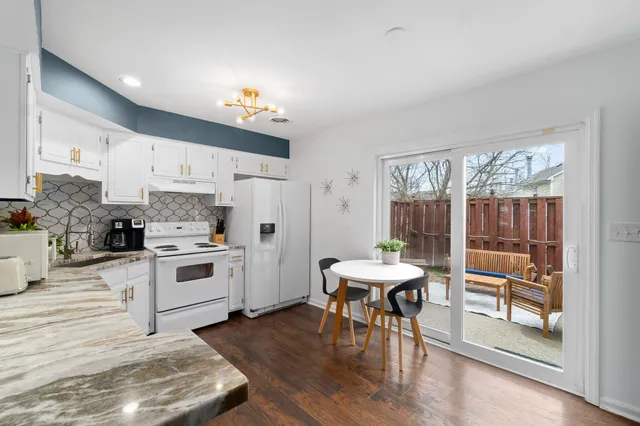 a kitchen with white cabinets and white appliances