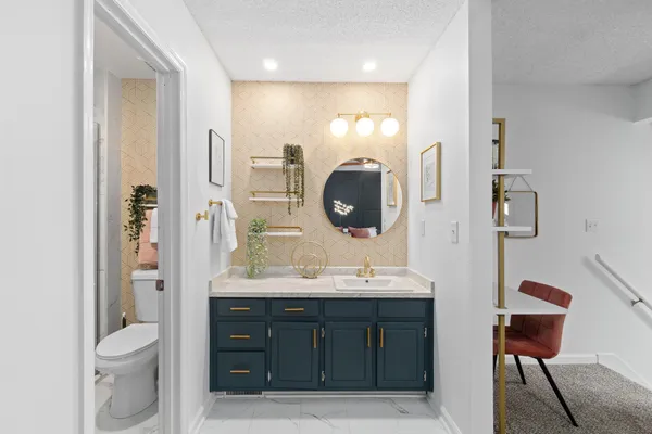 a bathroom with a toilet sink and mirror