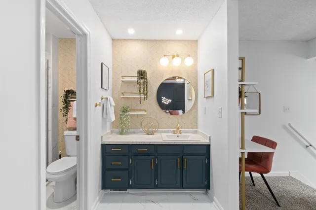 a bathroom with a toilet sink and mirror