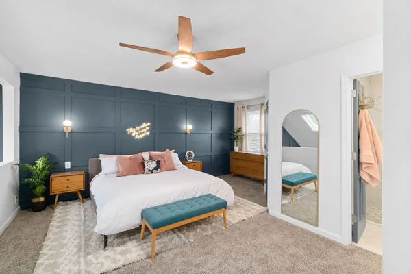 a bedroom with a bed table and window